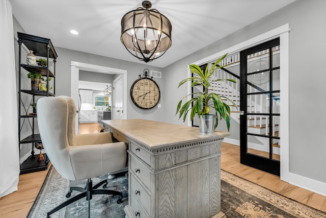 office space featuring light wood-style flooring, recessed lighting, visible vents, baseboards, and an inviting chandelier