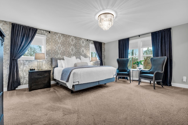 bedroom with a chandelier, carpet floors, multiple windows, and wallpapered walls