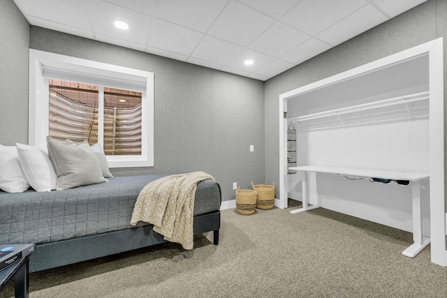 carpeted bedroom with a paneled ceiling, baseboards, and recessed lighting