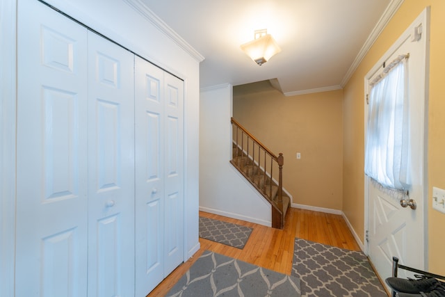 entryway with crown molding and hardwood / wood-style flooring