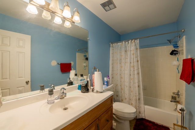 full bathroom featuring vanity, shower / bath combo, and toilet