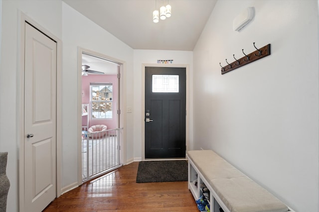 foyer with hardwood / wood-style floors and a notable chandelier