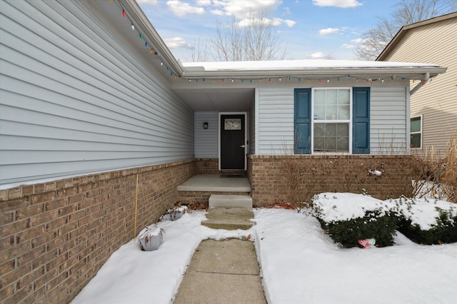 view of snow covered property entrance