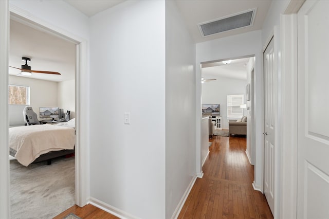 hallway with hardwood / wood-style floors