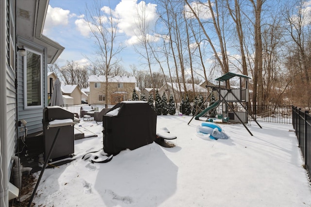 snowy yard with a playground