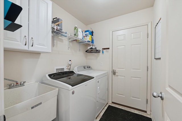 laundry area with cabinets, washer and clothes dryer, and sink