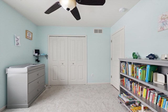 sitting room with ceiling fan and light carpet