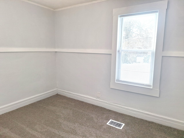 carpeted spare room with ornamental molding