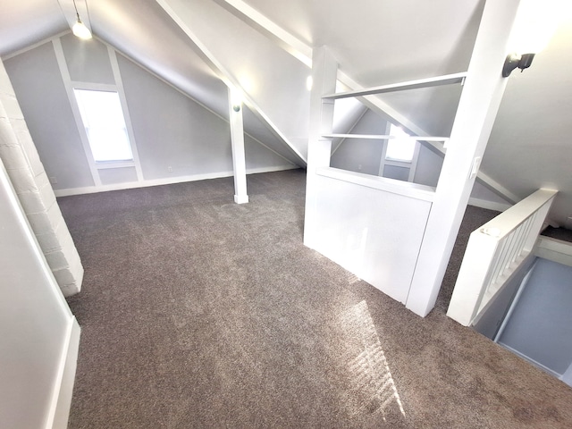 additional living space with lofted ceiling and dark carpet