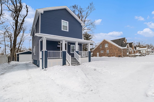 view of front of property featuring a garage, an outbuilding, and covered porch