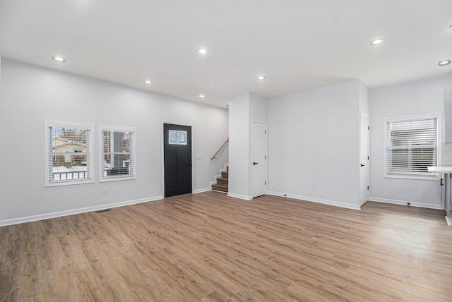 interior space featuring stairway, recessed lighting, light wood-style floors, and baseboards