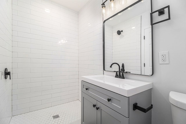 full bathroom with a shower stall, vanity, and toilet