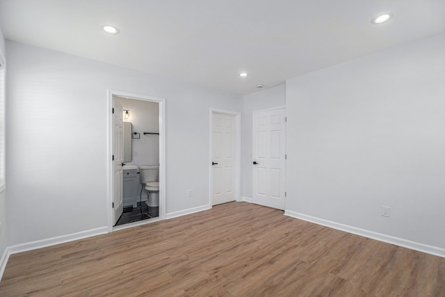 unfurnished bedroom with wood finished floors and recessed lighting