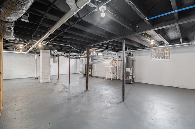 unfinished basement with a sink, heating unit, and water heater