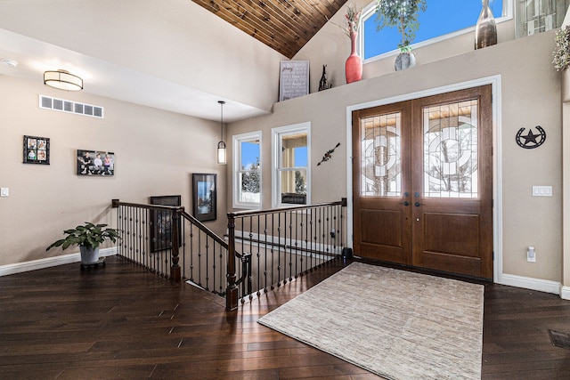 foyer featuring dark wood finished floors, visible vents, high vaulted ceiling, and baseboards