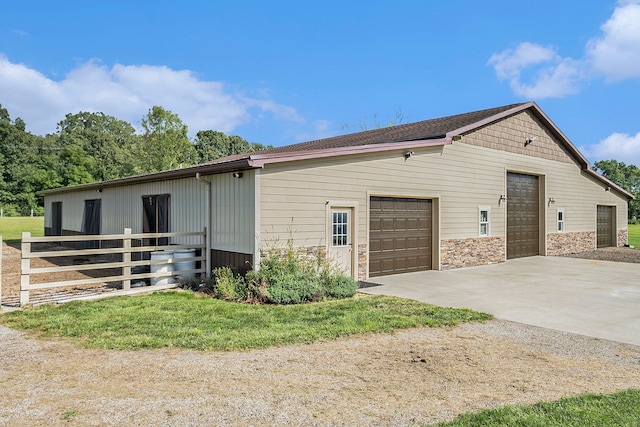 exterior space with stone siding and a garage