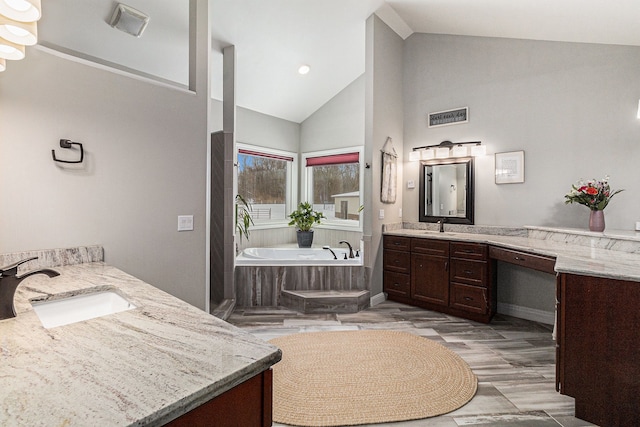 bathroom with a sink, visible vents, a bath, and two vanities