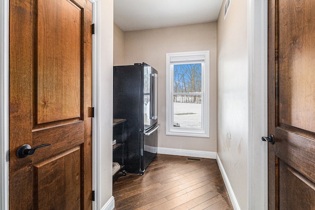 interior space featuring dark wood-style flooring, baseboards, and visible vents