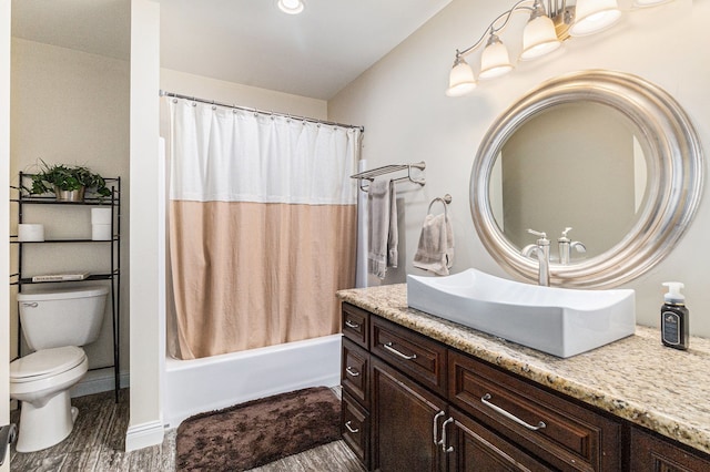 bathroom with vanity, shower / tub combo, and toilet