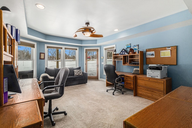 home office with baseboards, light carpet, recessed lighting, and a raised ceiling