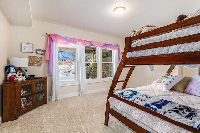 bedroom featuring baseboards and light colored carpet