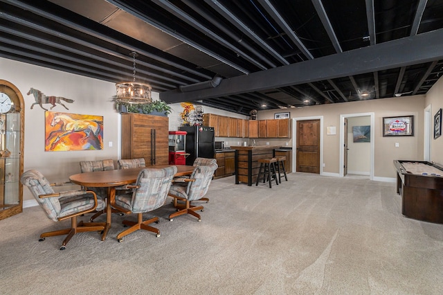 dining space with baseboards, light colored carpet, and beam ceiling