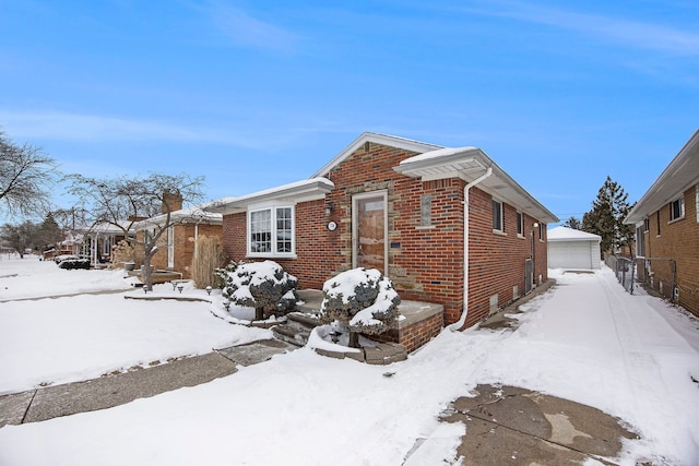 view of front of home with a garage and an outdoor structure