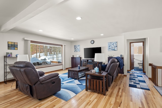 living area featuring recessed lighting, beamed ceiling, light wood-style flooring, and baseboards