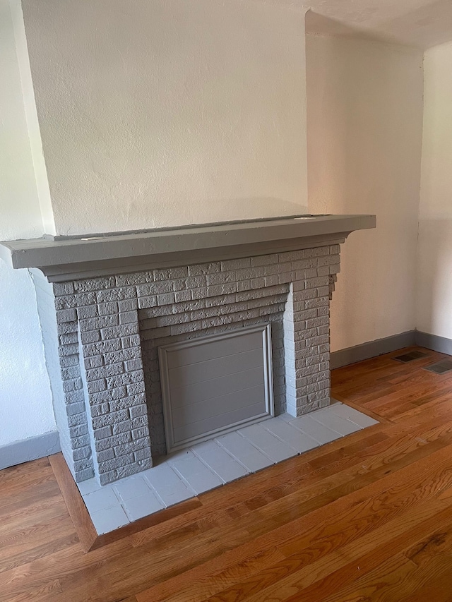 room details featuring hardwood / wood-style floors and a fireplace