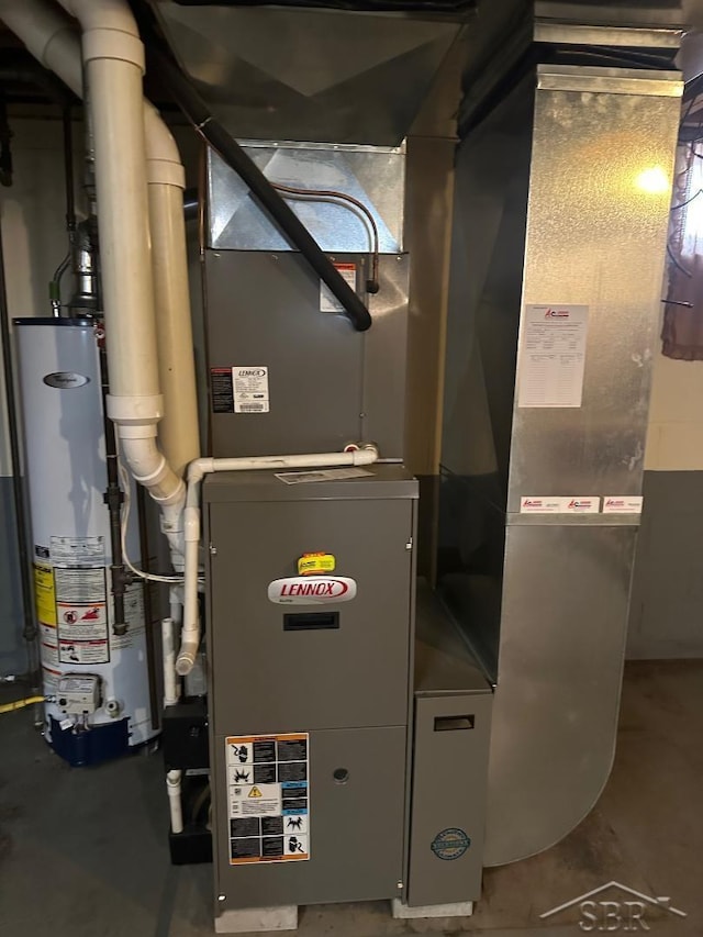 utility room featuring heating unit and water heater