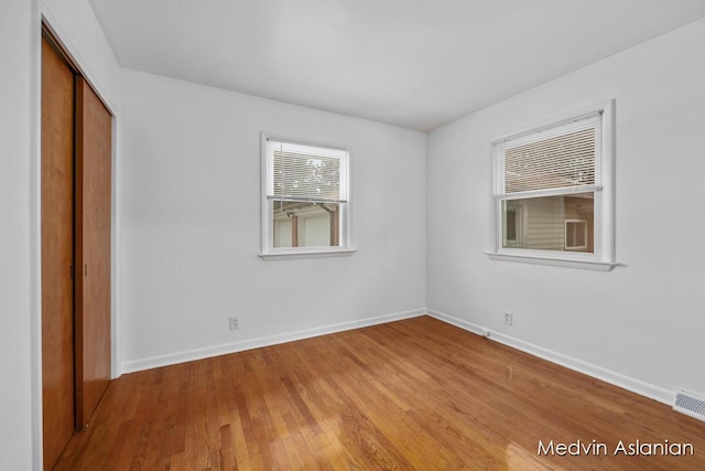 unfurnished room with light wood-type flooring