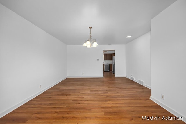 interior space with an inviting chandelier and wood-type flooring