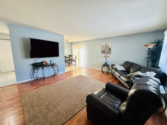 living room with a textured ceiling and wood finished floors