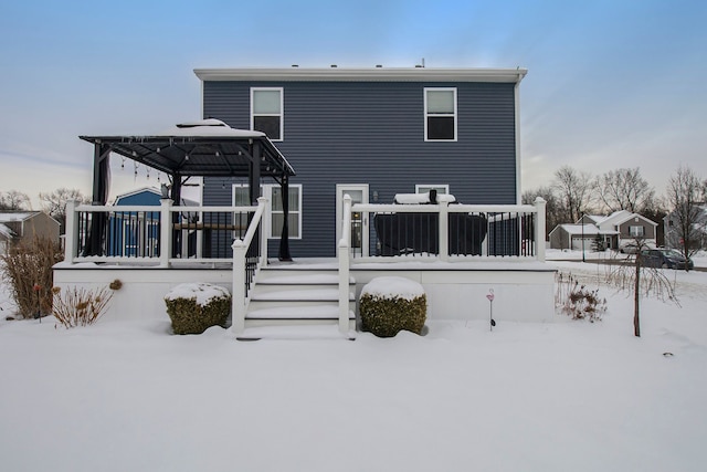 snow covered property with a deck and a gazebo