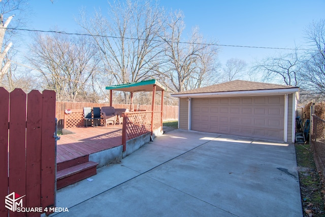 detached garage featuring fence