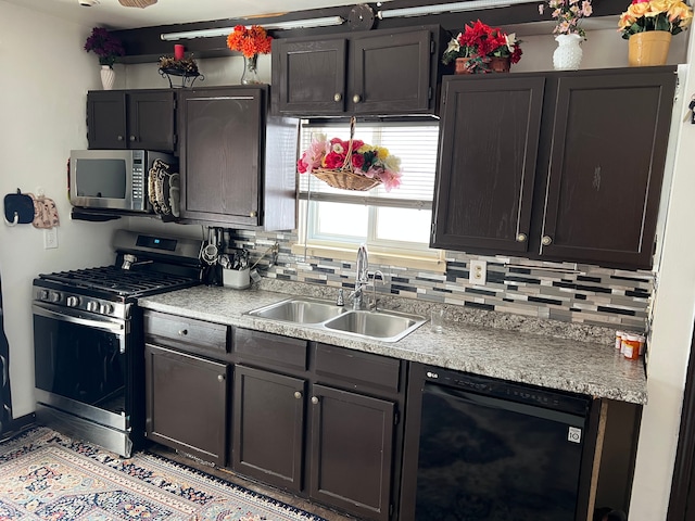 kitchen with appliances with stainless steel finishes, light countertops, a sink, and decorative backsplash