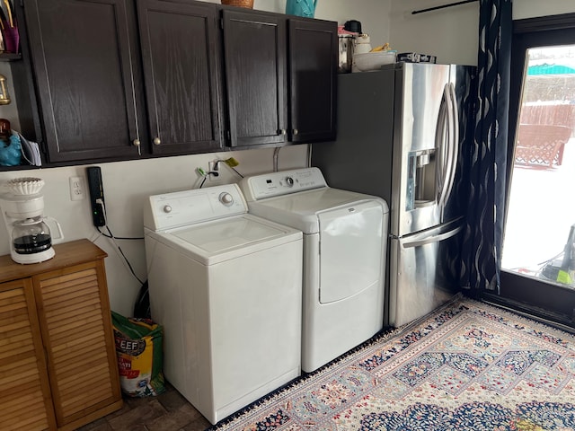 washroom featuring a wealth of natural light, cabinet space, and separate washer and dryer