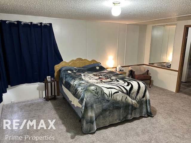 carpeted bedroom featuring a textured ceiling