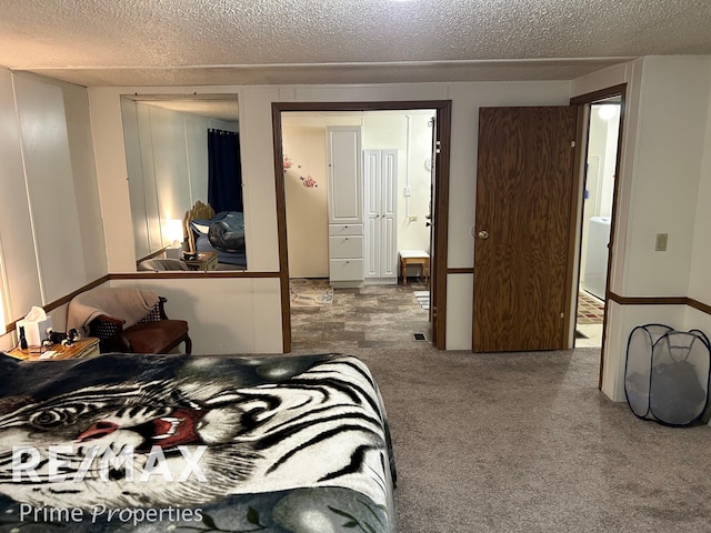 carpeted bedroom featuring a textured ceiling