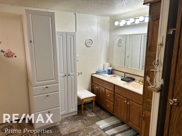 bathroom featuring vanity and a textured ceiling