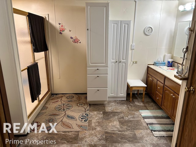 bathroom featuring vanity and an enclosed shower