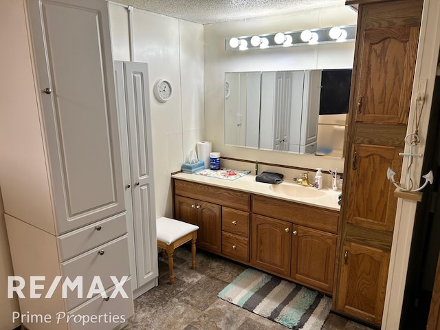 bathroom featuring vanity and a textured ceiling