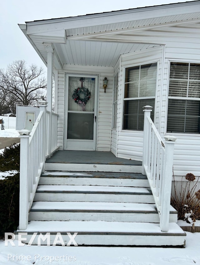 view of snow covered property entrance