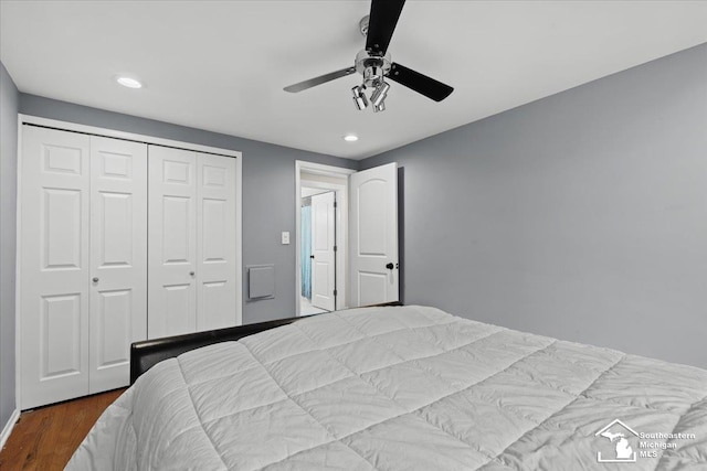 bedroom featuring wood-type flooring, ceiling fan, and a closet