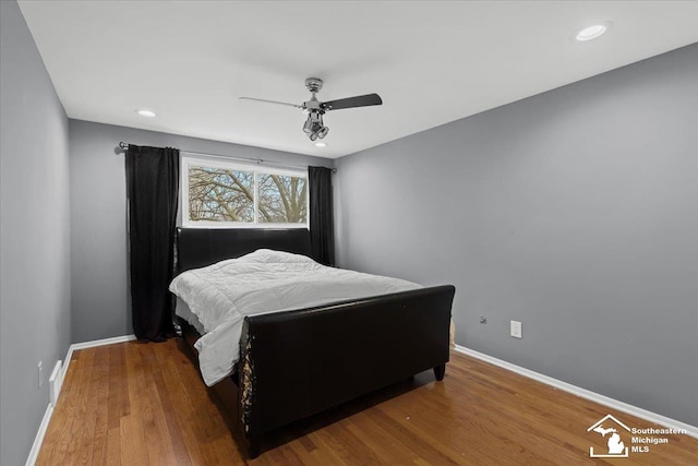 bedroom with hardwood / wood-style floors and ceiling fan