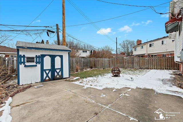 view of patio with a storage shed and an outdoor fire pit