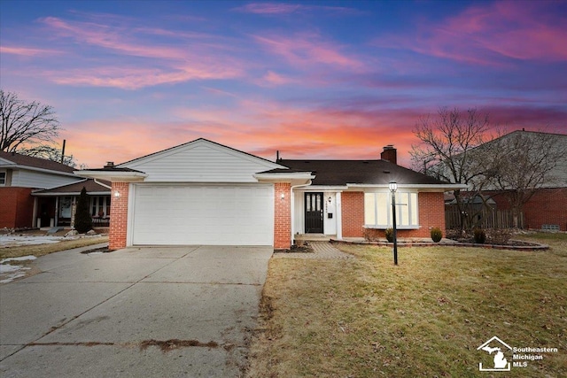 single story home featuring a yard and a garage