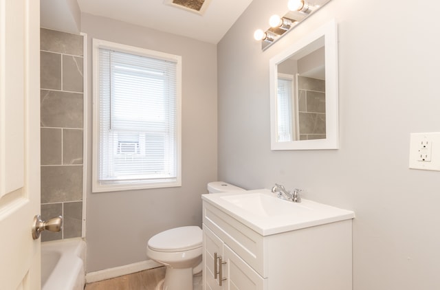 full bathroom with vanity, hardwood / wood-style floors, shower / tub combination, and toilet