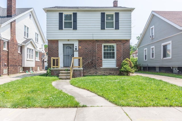 view of property featuring a front lawn