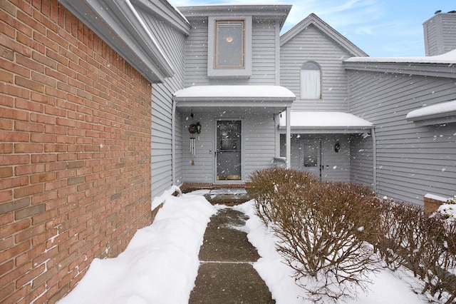 view of snow covered property entrance